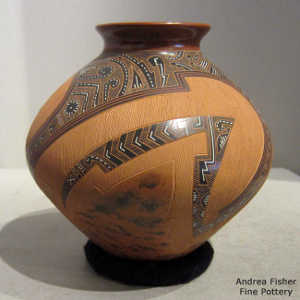Sgraffito and painted shard and geometric design on a polychrome brown jar