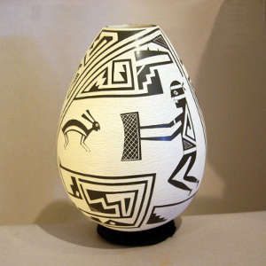 Sgraffito Mimbres human, animal and geometric design on a black and white jar