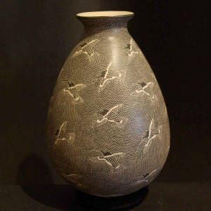 Sgraffito hummingbirds motif on a black and white jar