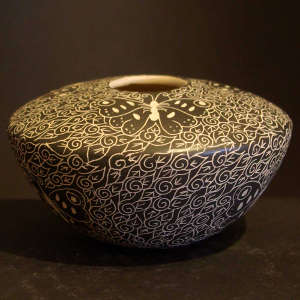 Sgraffito butterfly and geometric designs on a black and white broad shouldered jar