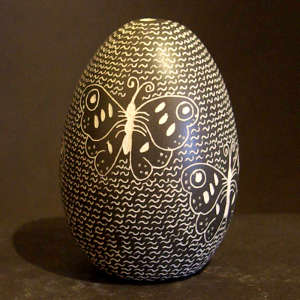 Sgraffito butterfly and mesh design on a black and white seed pot