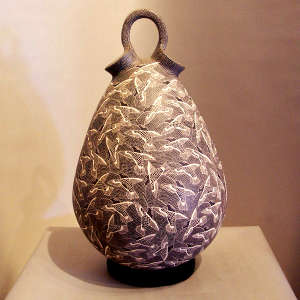 A sgraffito hummingbird and mesh design on a black and white stylized wedding vase