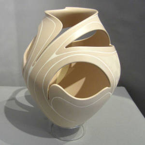 Sgraffito fine line and painted geometric designs on a cream on tan sculptural piece with organic openings