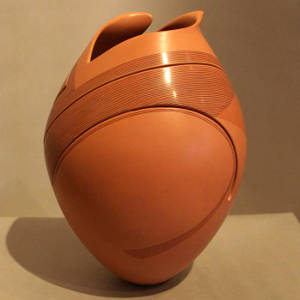 Painted and incised lines on a carved jar with an organic opening