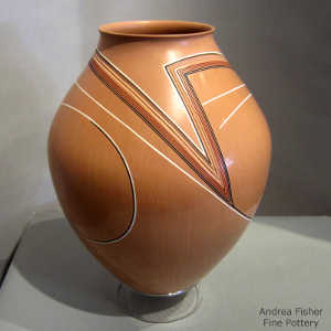 Lightly carved lines and geometric design on a polychrome jar