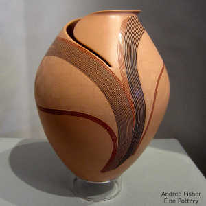 Lightly carved lines and geometric design on a polychrome jar with an organic opening