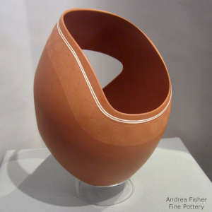 Organic openings and sgraffito fine line geometric design on a cream on red sculptural piece