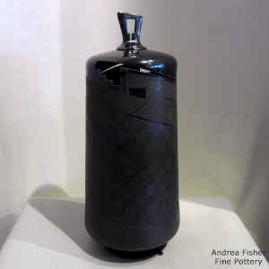 Sgraffito and painted geometric design on a black on black lidded jar