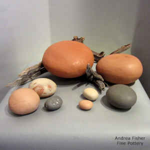 9 pieces in a polychrome sculptural nature setting, with driftwood