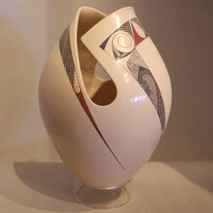 Sgraffito and fine line design on a white jar with an organic opening