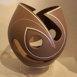 Cutouts and fine line design on a brown sculptural piece
