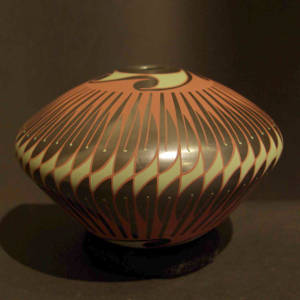 Polished black graphite jar decorated with a polychrome geometric design