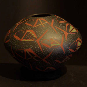 Red and green fish motif on a black jar