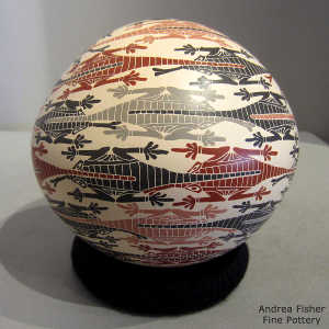 Lizard and geometric design on a polychrome seed pot