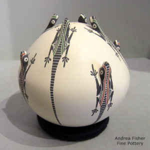 Sgraffito, painted and applique lizard design on a polychrome seed pot