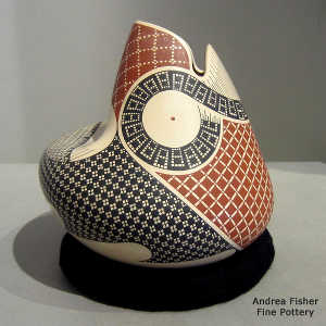 Geometric design on a polychrome stylized bird sculptural piece
