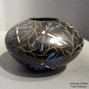 Sgraffito and painted dragonfly and vine motif on a polychrome jar