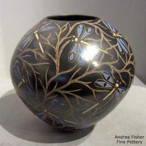 Sgraffito and painted dragonfly and vine motif on a polychrome jar