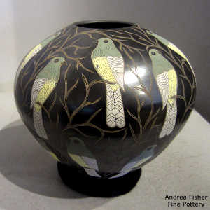 Sgraffito and painted parrot and vines motif on a polychrome jar