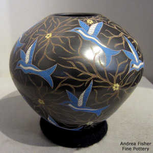 Sgraffito and painted hummingbirds and vines motif on a polychrome jar