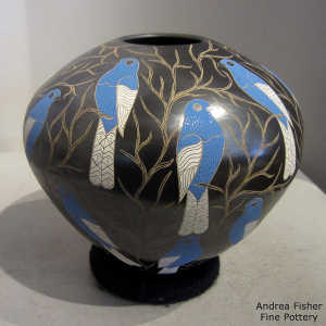 Sgraffito and painted bluebird and vines motif on a polychrome jar