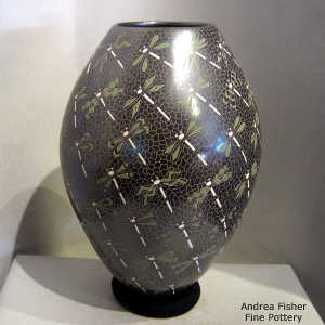 Sgraffito and painted dragonfly and mesh motif on a polychrome jar