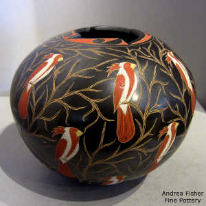 Sgraffito and painted parrot and branches motif on a polychrome jar with a geometric cut opening
