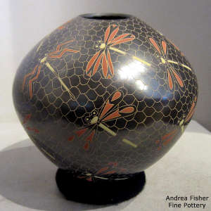 Sgraffito and painted dragonfly and mesh motif on a polychrome jar