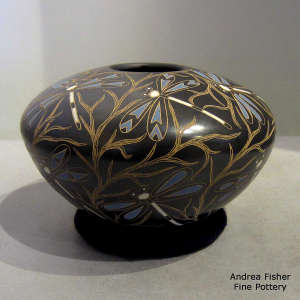 Sgraffito and painted dragonfly and branches motif on a polychrome jar