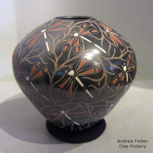 Sgraffito and painted dragonfly and branch motif on a polychrome jar