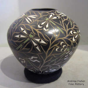 Sgraffito and painted dragonfly and branch motif on a polychrome jar