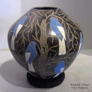 Sgraffito and painted bird, flower and branch motif on a polychrome jar
