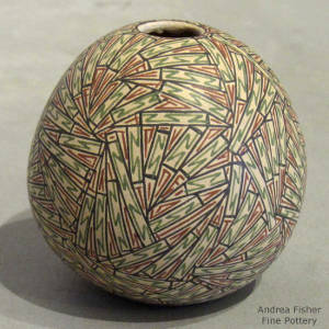 Green, red and black geometric designs on a polychrome seedpot