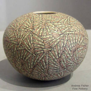 Red, green and black fine line geometric designs on a polychrome seedpot