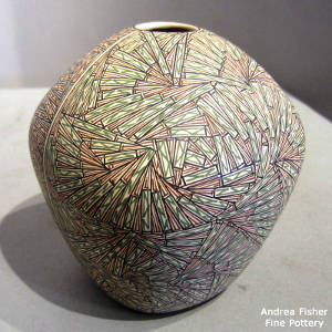 Green, black and red fine line geometric designs on a squarish pot