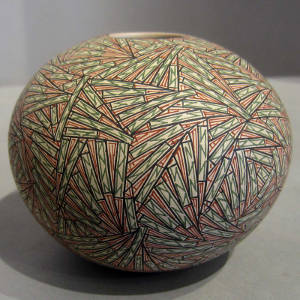 Red, black and green fine line designs on a white seedpot