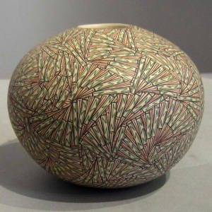 Black, red and green fine line geometric design on a seedpot