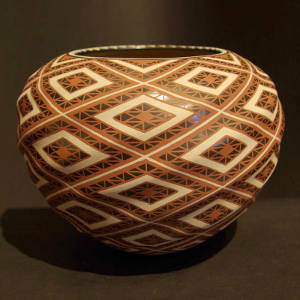 Geometric designs decorate a polychrome graphite jar