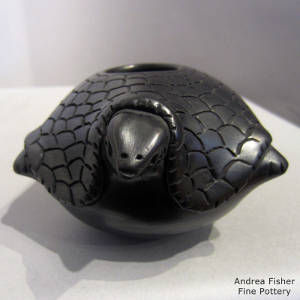 Carved shell on a black turtle figure