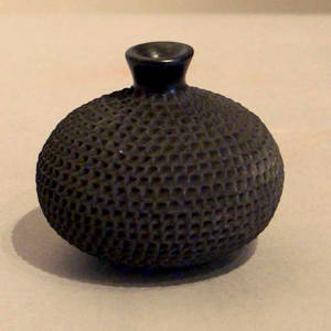Corrugated surface on a thin necked black jar