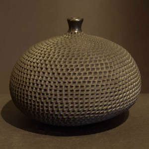 Corrugated surface on a thin neck black jar