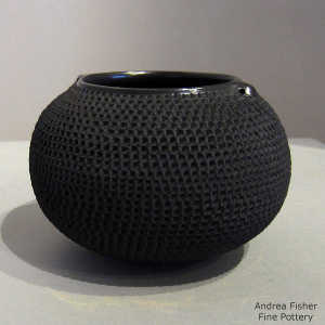 A corrugated surface on a black jar with handles