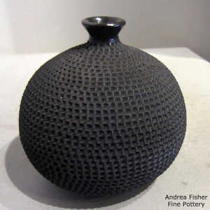 Corrugated surface on a thin-necked black jar