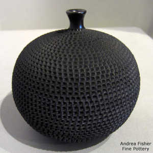 Corrugated surface on a black thin neck jar