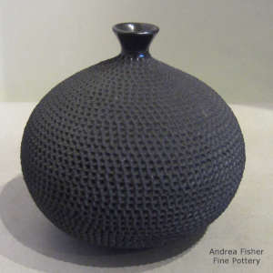 Corrugated surface on a thin neck black vase