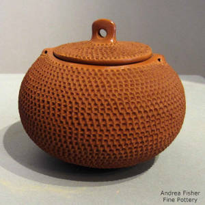 Red jar and lid with corrugated surfaces