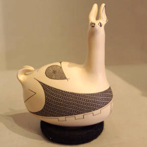 Black and red geometric design on a resting llama figure