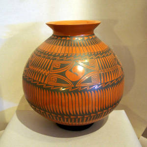 Black feather and geometric design on a red jar
