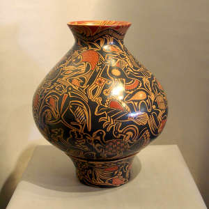Animal and geometric design on a polychrome jar with a matching custom stand