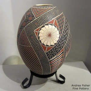 Geometric design on a polychrome jar with a custom stand